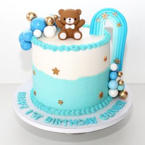 Nahaufnahme des farblich abgestimmten Regenbogens aus Fondant auf der Baby-Torte